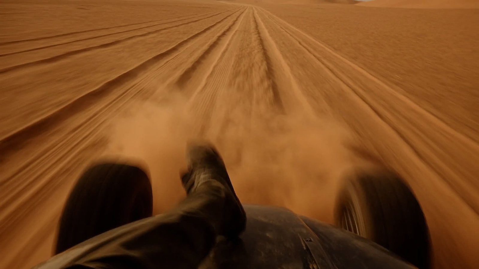 A 4x4 kicking up sand on open desert tracks toward Erg Chegaga